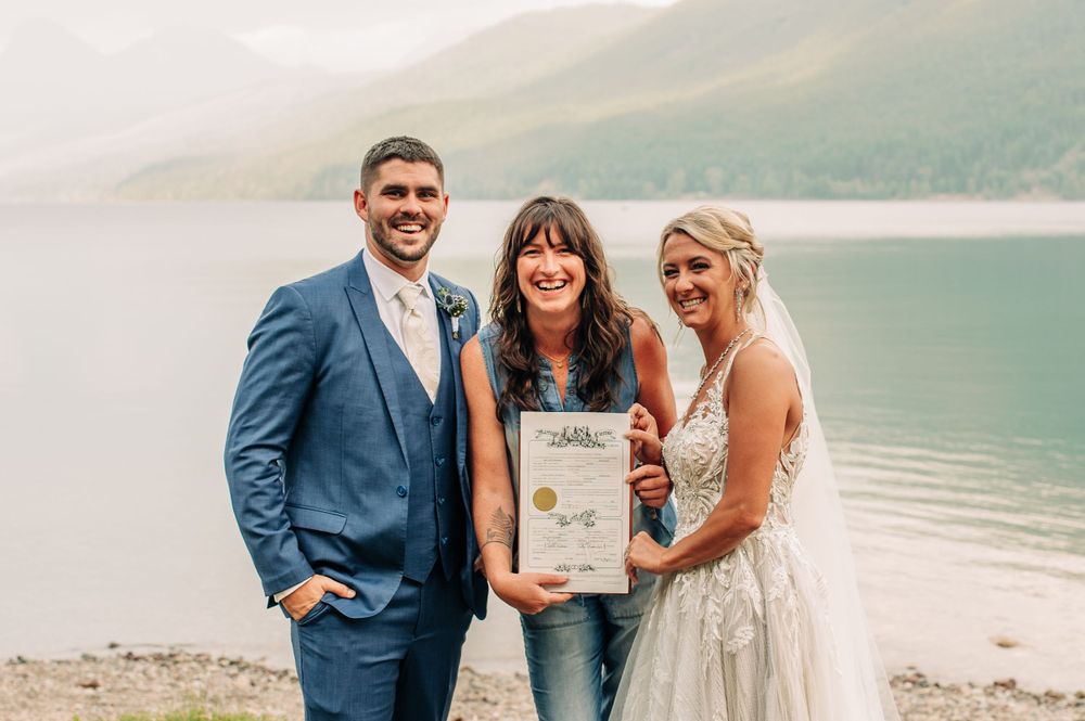 wedding couple with their officiant on their wedding day
