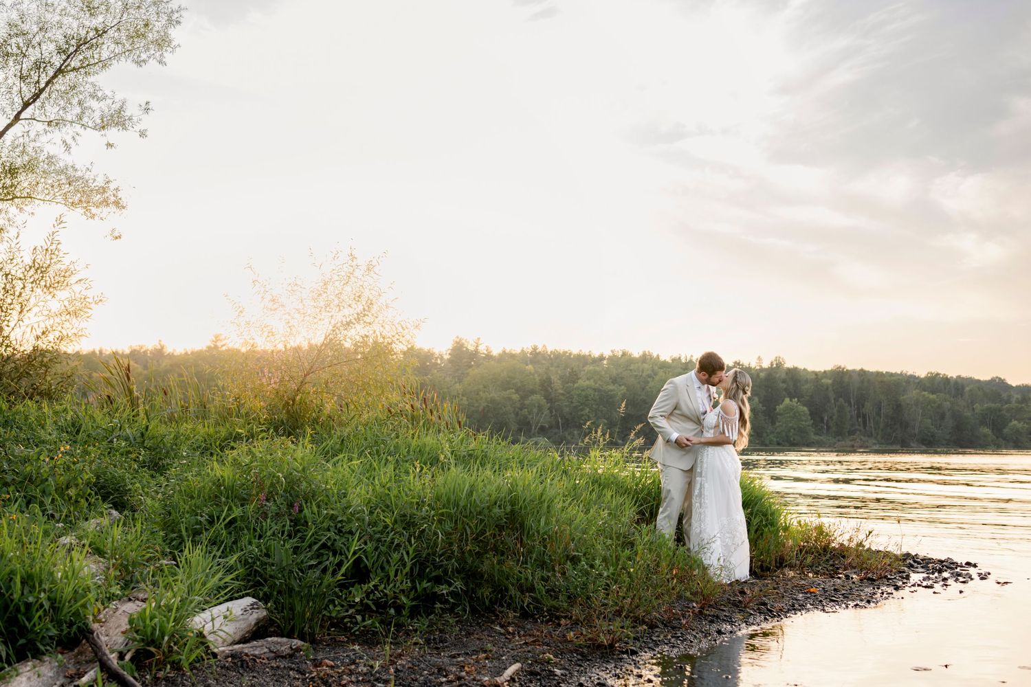 bride and groom lake side at sunset at The Lake house Inn