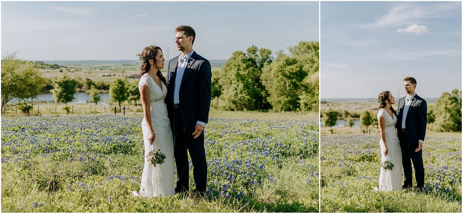 Wedding couple poses in a wildflower meadow with panoramic countryside views.