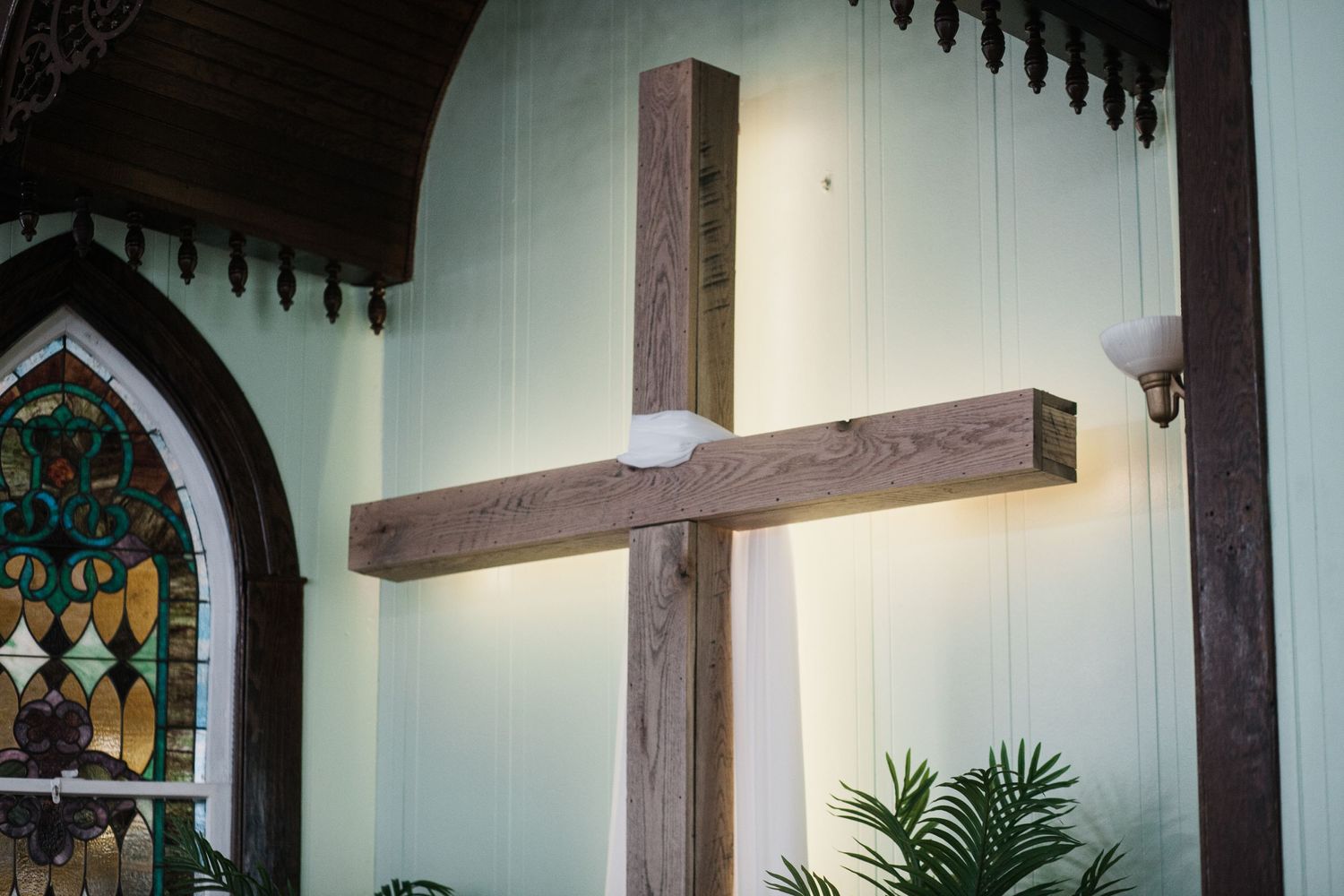 Beautiful church interior with stained glass windows and wooden beams.