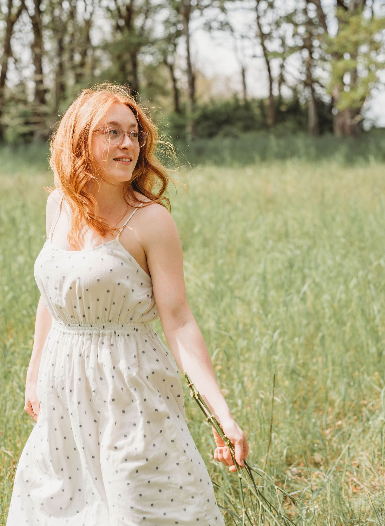 White floral dress movement captured in a sunny field with natural lighting.