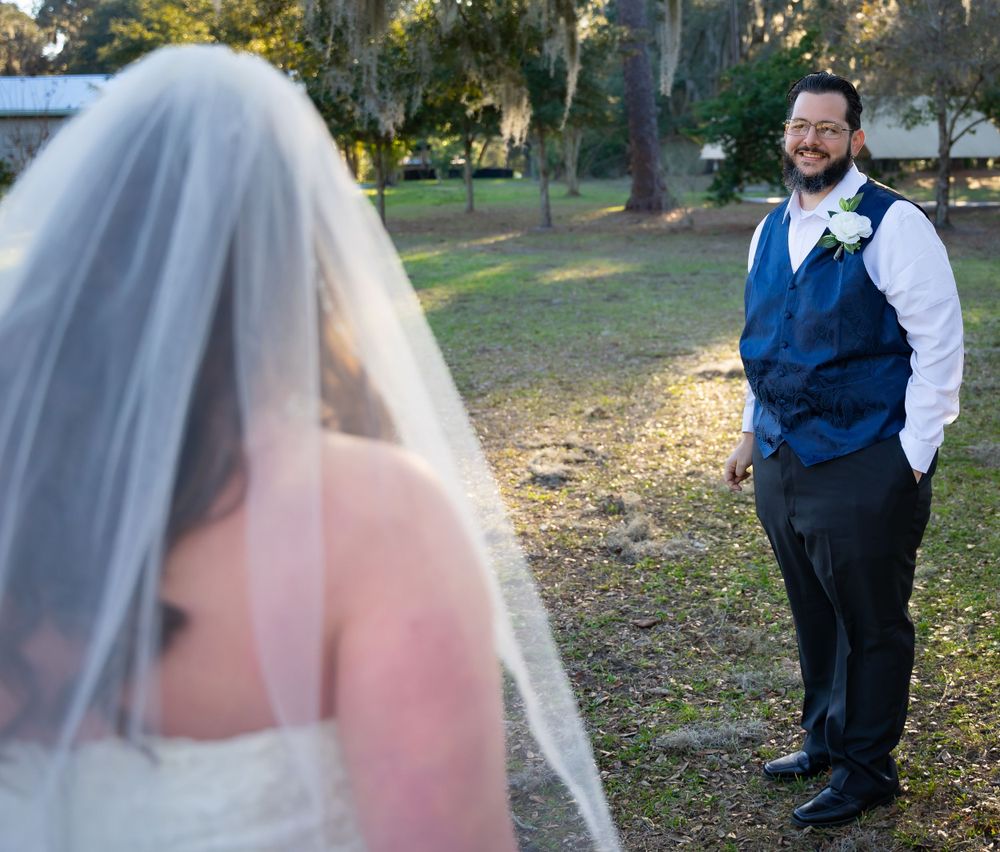 Wedding couple poses playfully together during their autumn outdoor photography session.
