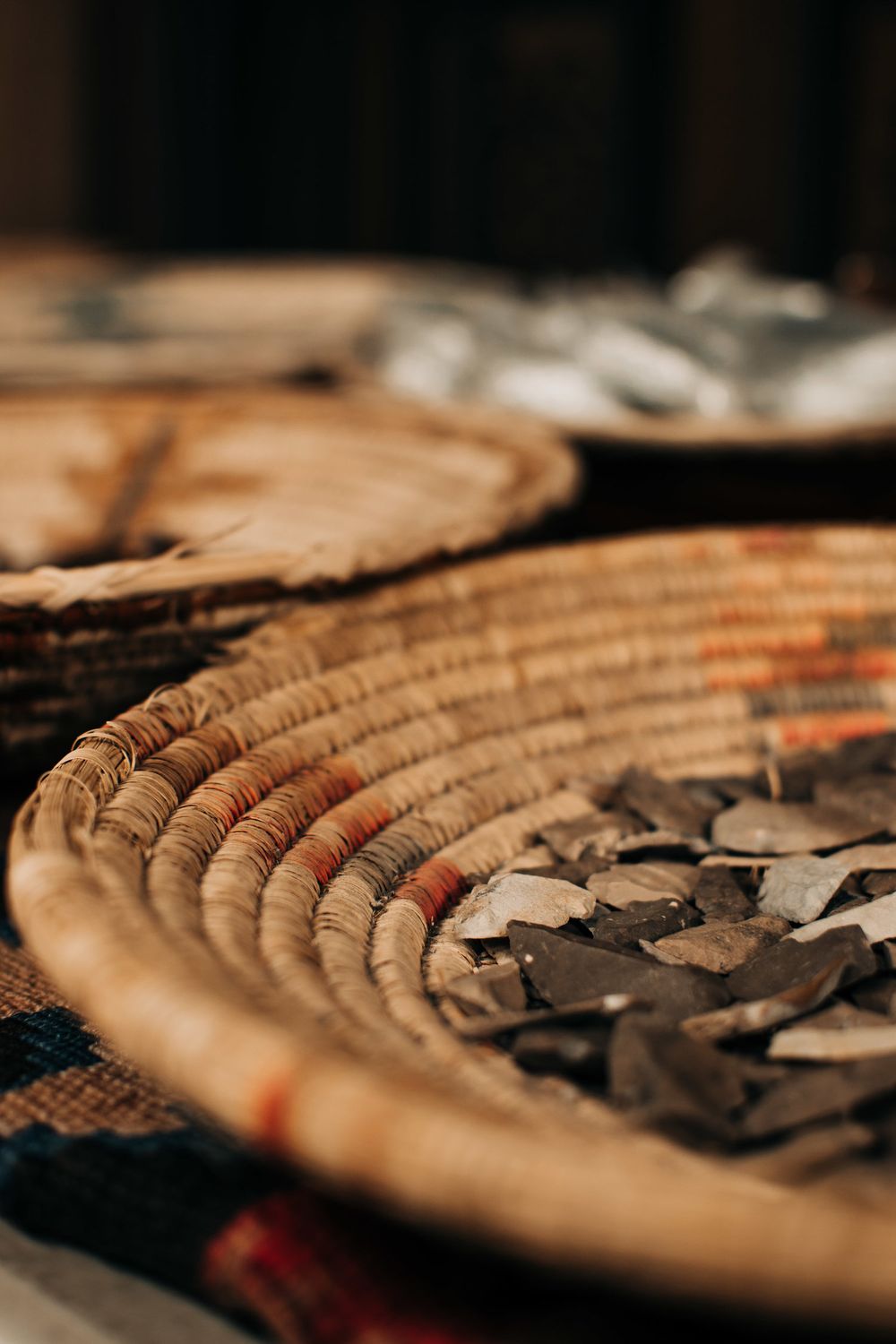 Close-up of a traditional woven basket with dried herbs or leaves.