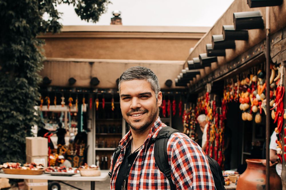 Outdoor market stall displaying colorful handmade goods and decorative items.