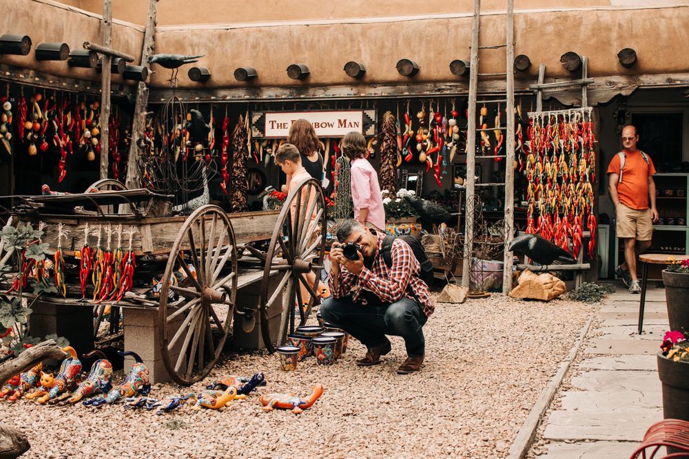 Southwestern marketplace with traditional wooden wagon wheels and hanging decorative items.