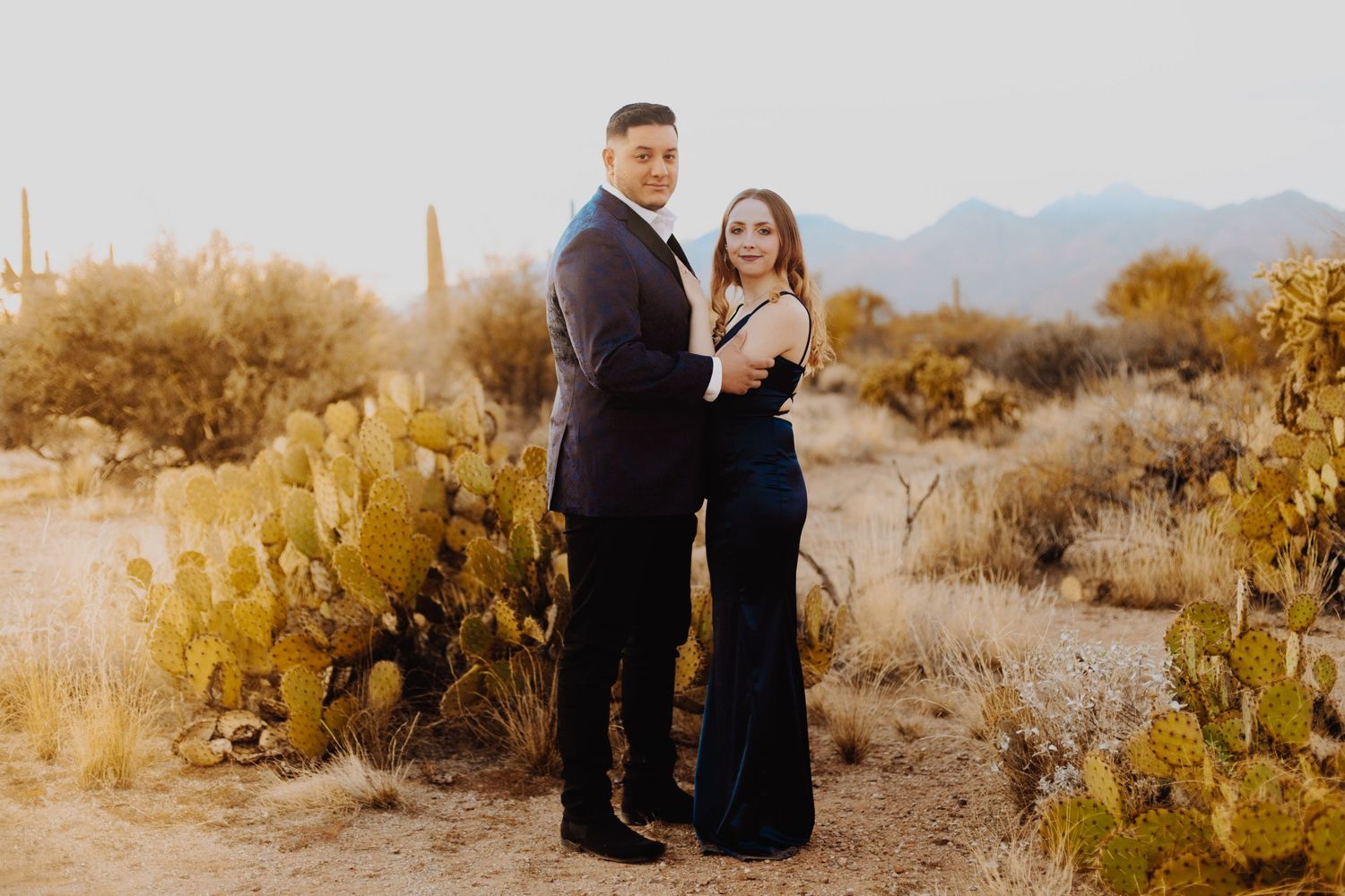 Desert landscape photoshoot with mountains and cacti at golden hour.