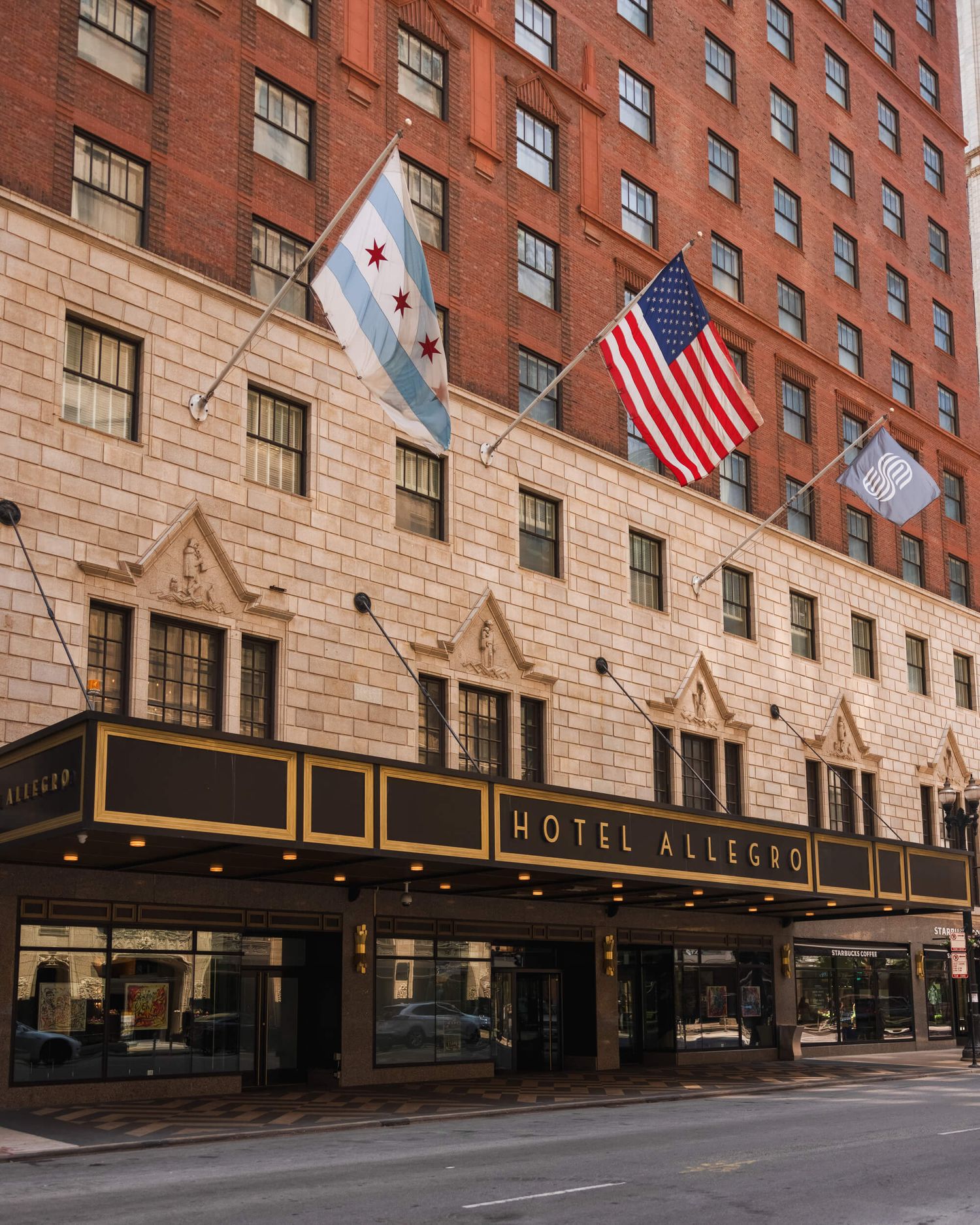 Hotel Allegro building exterior in Chicago with American flag displayed.