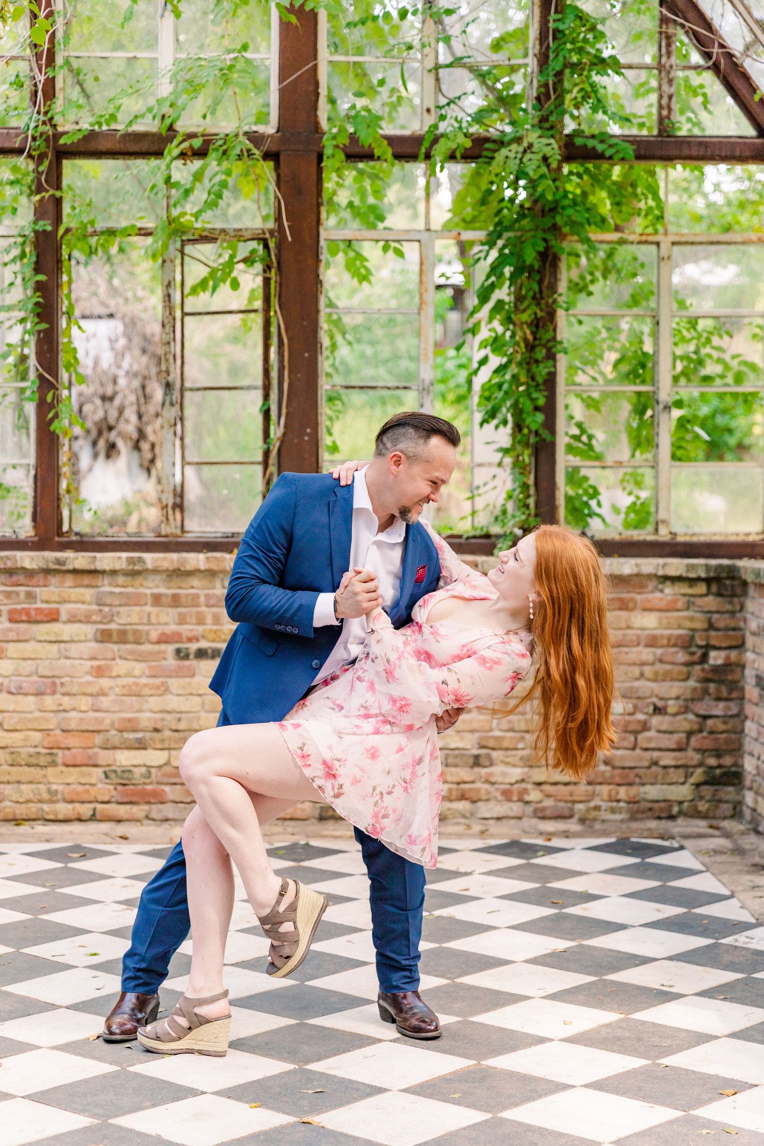 couple doing a dance dip in large greenhouse Sekrit Theater