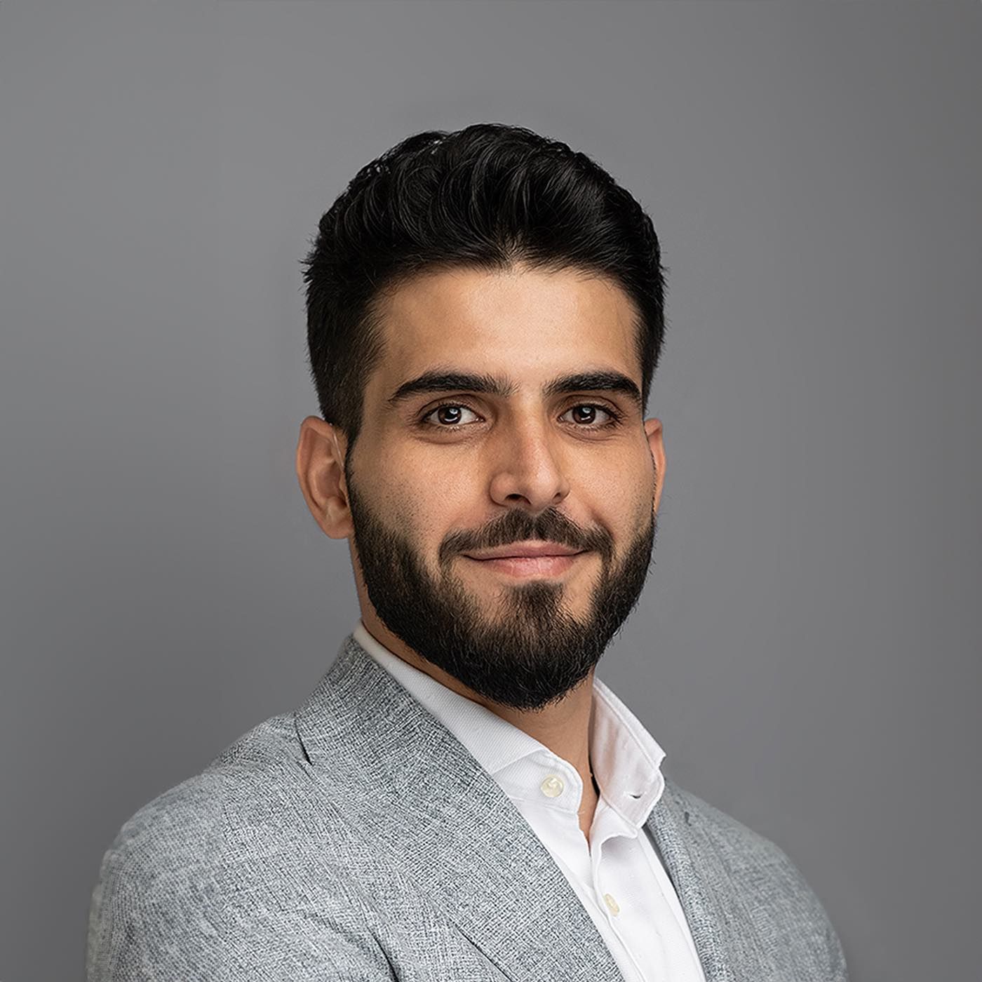 Orlando headshot photographer Ray Alvarez — young professional headshot in gray blazer with clean studio background