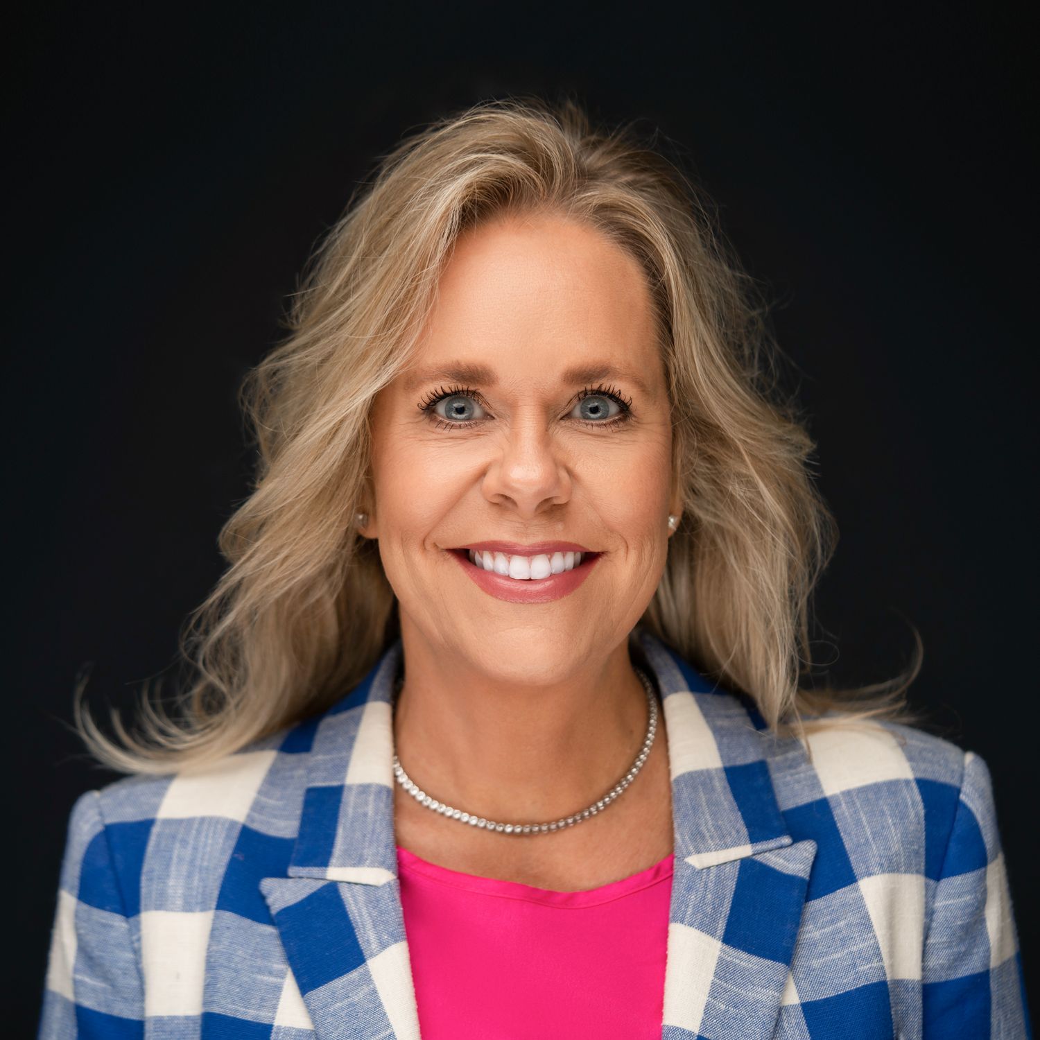Orlando headshot photographer Ray Alvarez — female executive headshot in blue plaid blazer with bold confident styling
