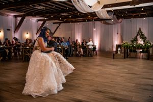 Bride sits on grooms lap for first dance as he is in a wheelchair