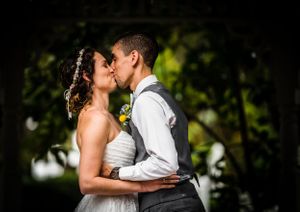 bride and grooms first kiss during the ceremony, captured with a nikon d750 and 70-200mm lens.