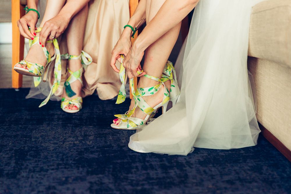 Wedding party showing off colorful mint green shoes against a navy carpet.