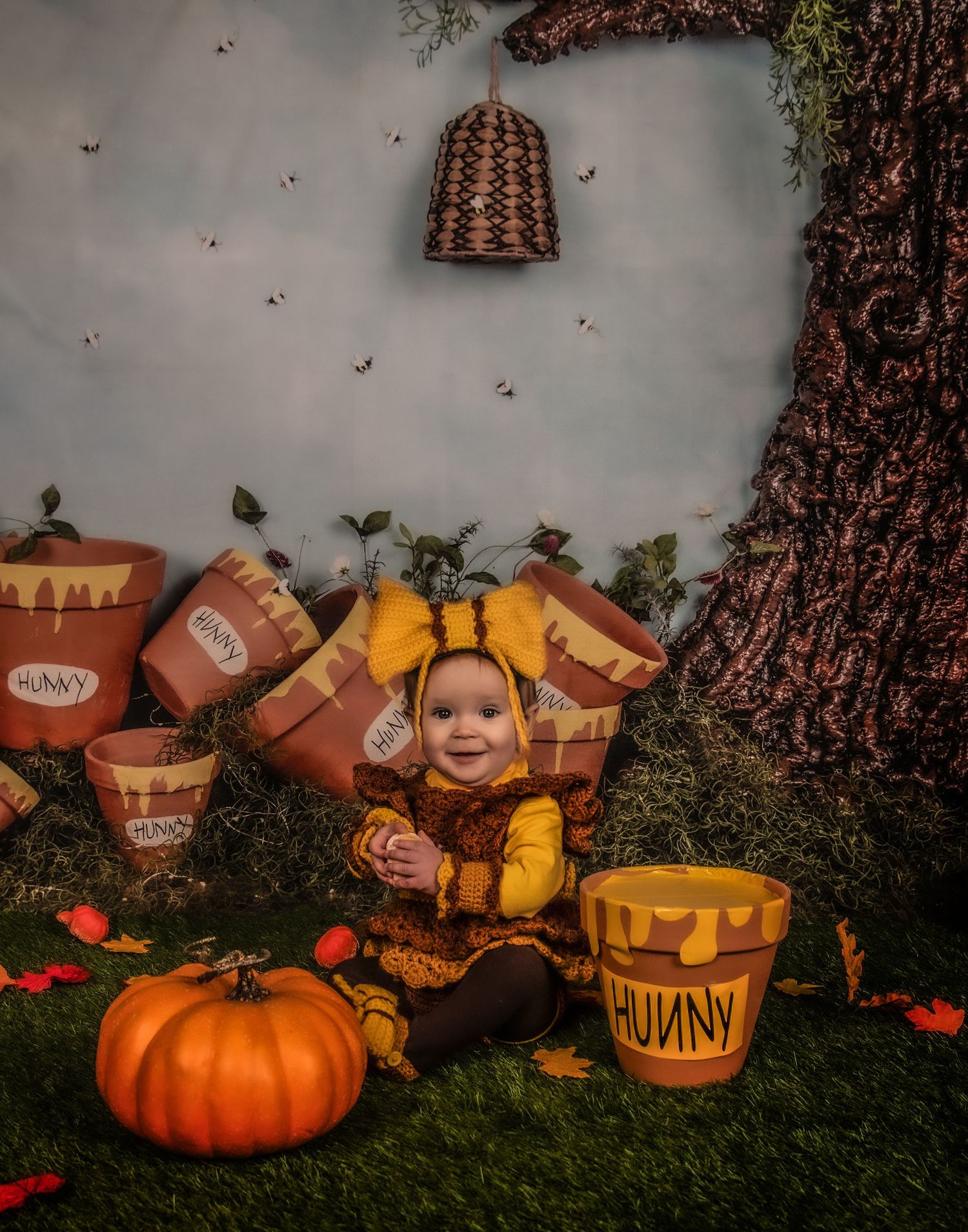 Whimsical honey pot themed setting with pumpkins and honeycomb decorations.