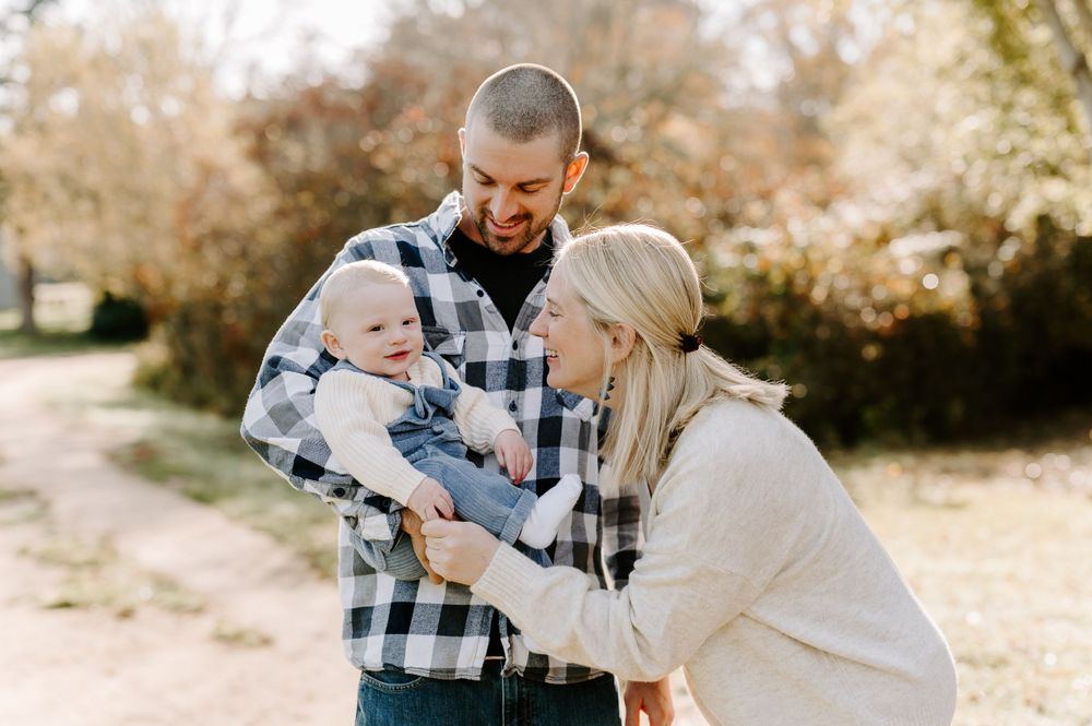 Family enjoying a tender moment together outdoors during golden hour.