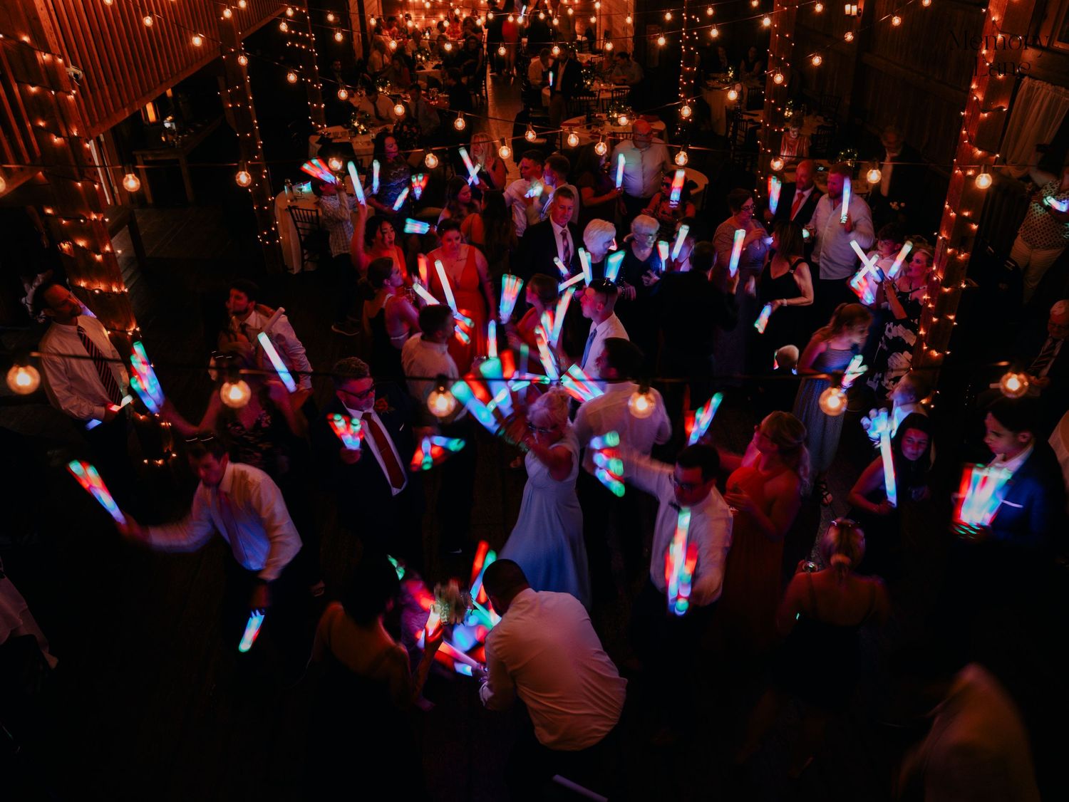 Energetic dance floor scene with string lights creating a magical atmosphere.