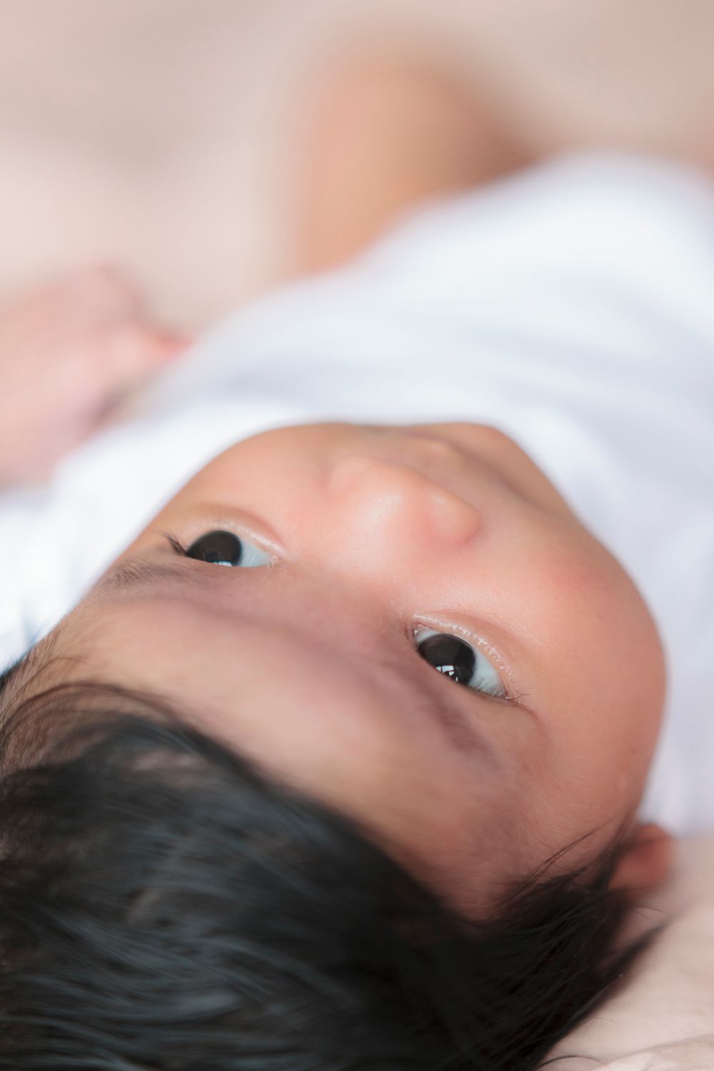 Close-up detail of baby girl's face, photographed during a newborn session at home in the Upper West Side by Paula Ortiz