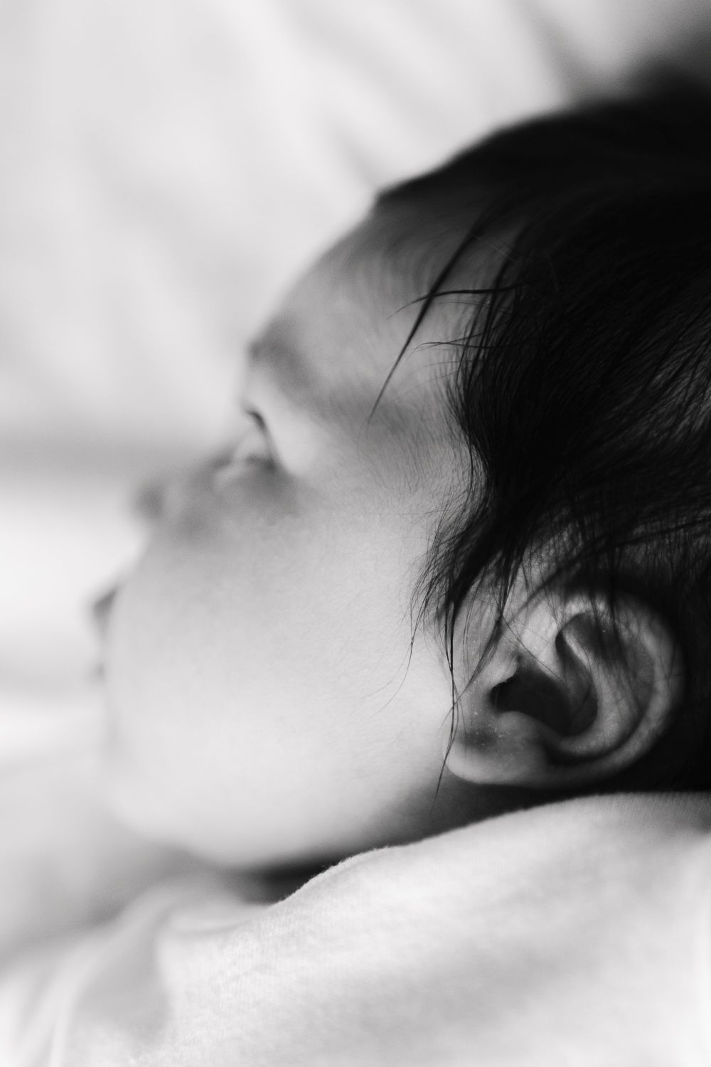 Close-up detail of baby's ear, captured by NYC photographer Paula Ortiz