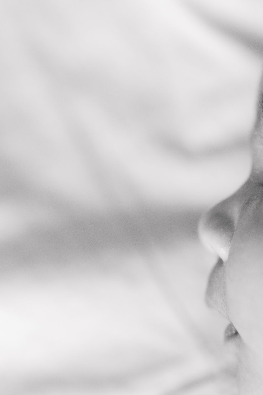 Close-up detail of baby's nose, photographed during a newborn session at home in NYC by Paula Ortiz