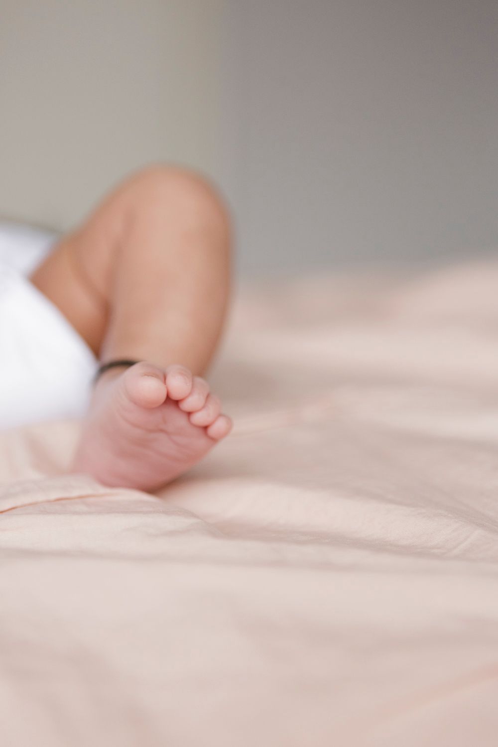 Close-up detail of baby's tiny foot, photographed by Paula Ortiz during a newborn session at home in NYC