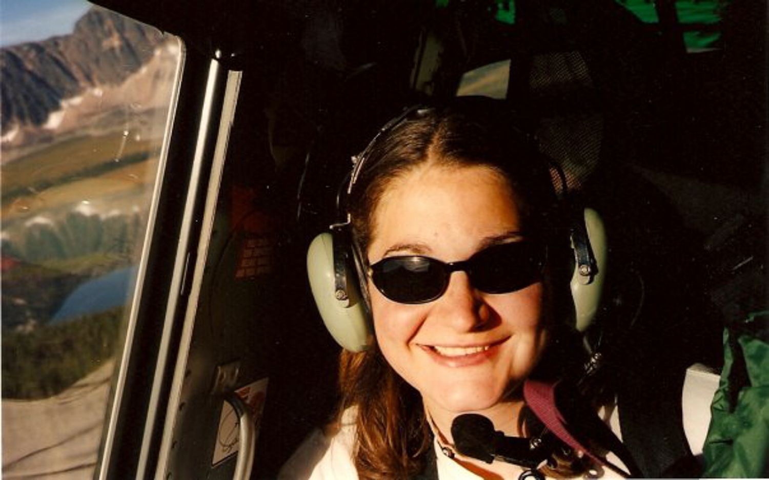 Picture of a 20 something Kelly in a helicopter flying into the Tonquin Valley, Jasper AB Canada
