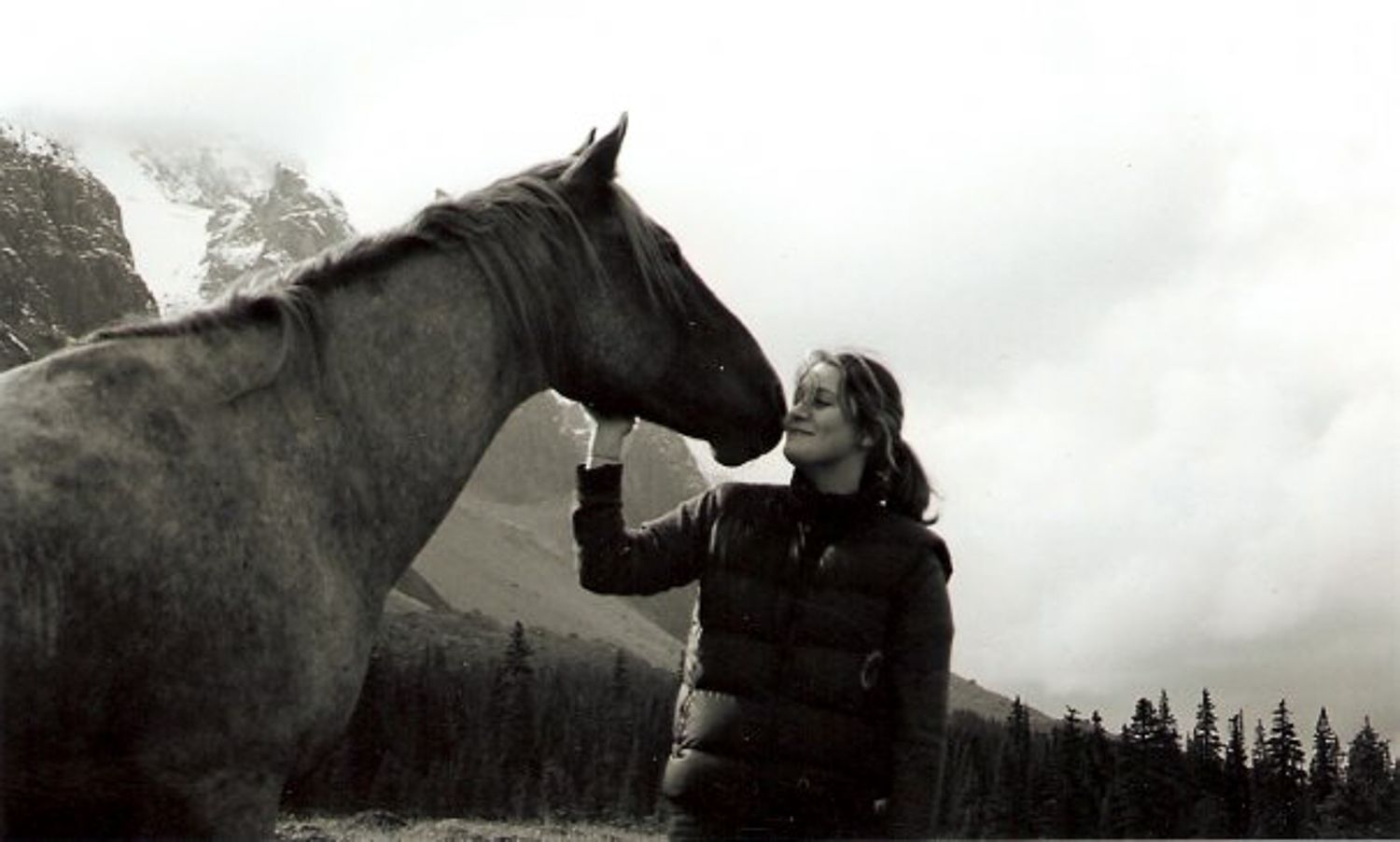Tonquin Valley horse nuzzles up to Kelly Manweiler in the valley.