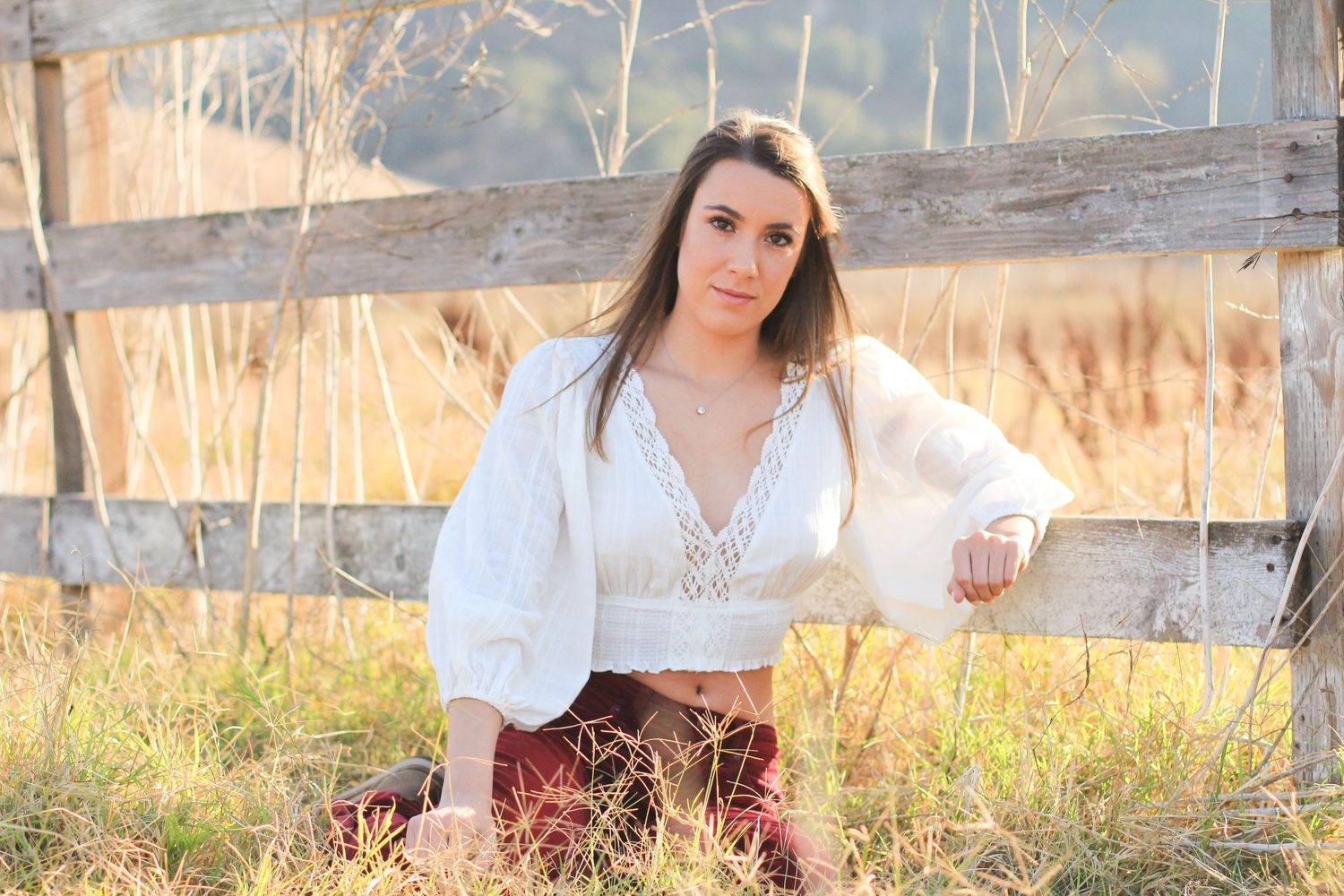Girl leans against fence in Edna Valley