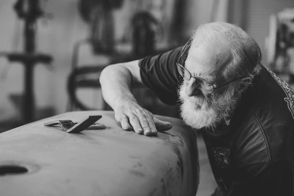 Man sanding car parts.