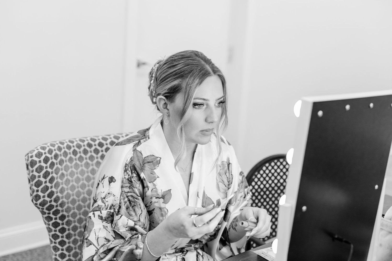 Wedding preparation scene with floral robes in natural light.