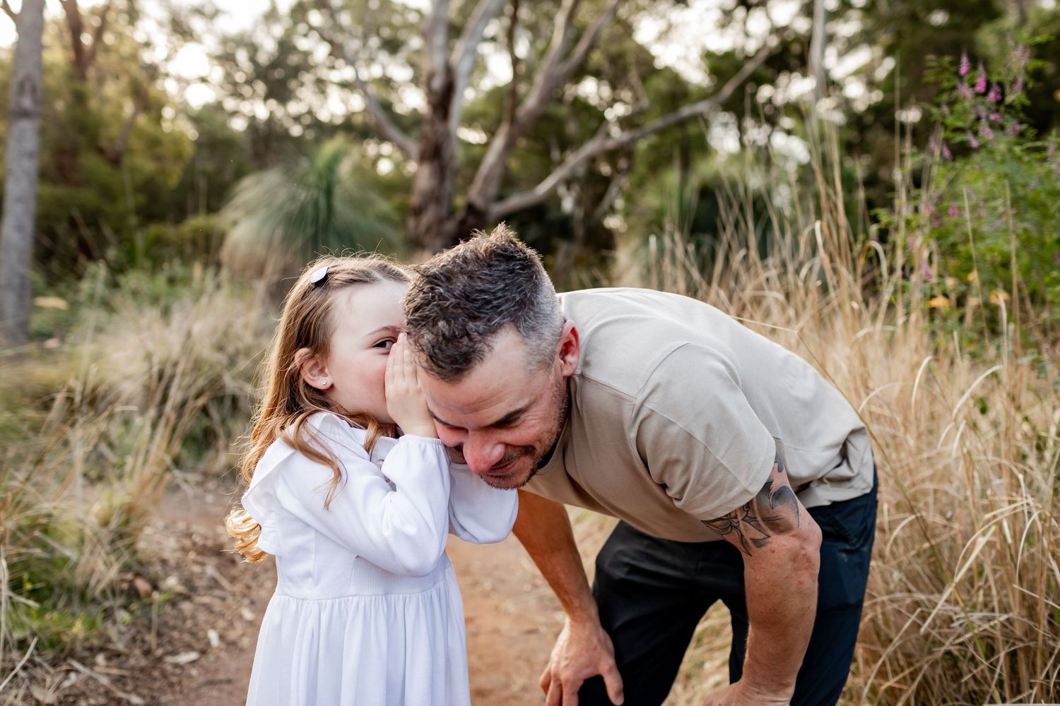 An intimate family moment shared between parent and child on a bush walking trail.