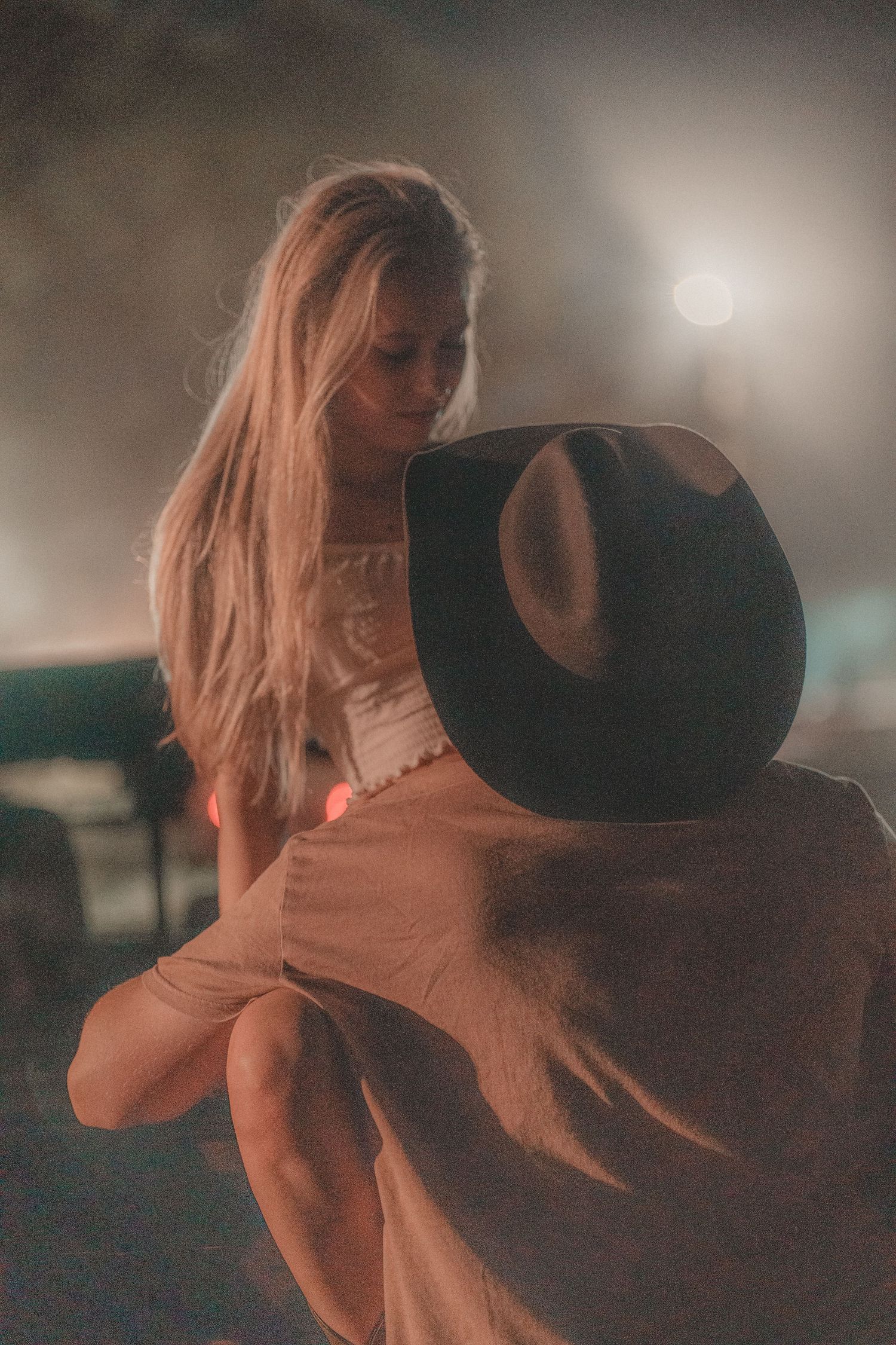 Dreamy sunset silhouette of couple sharing an intimate moment outdoors.
