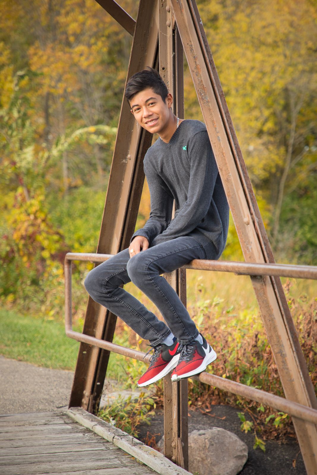 guy on bridge railing, fall portrait