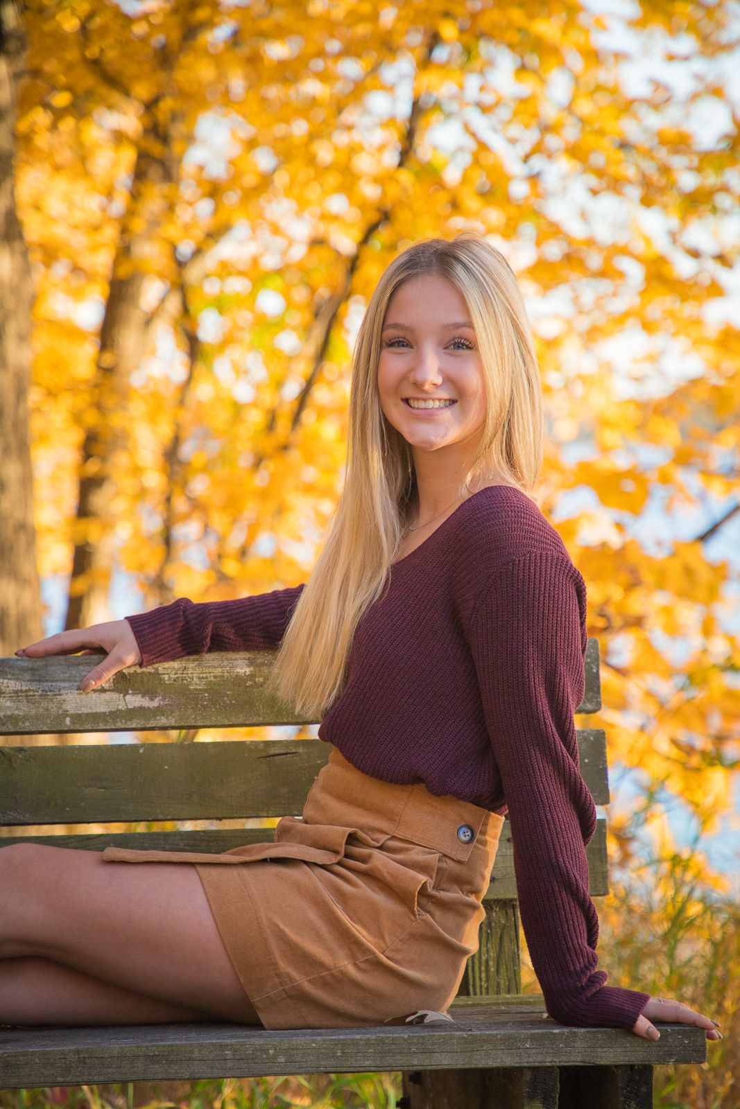 fall portrait of girl sitting on bench