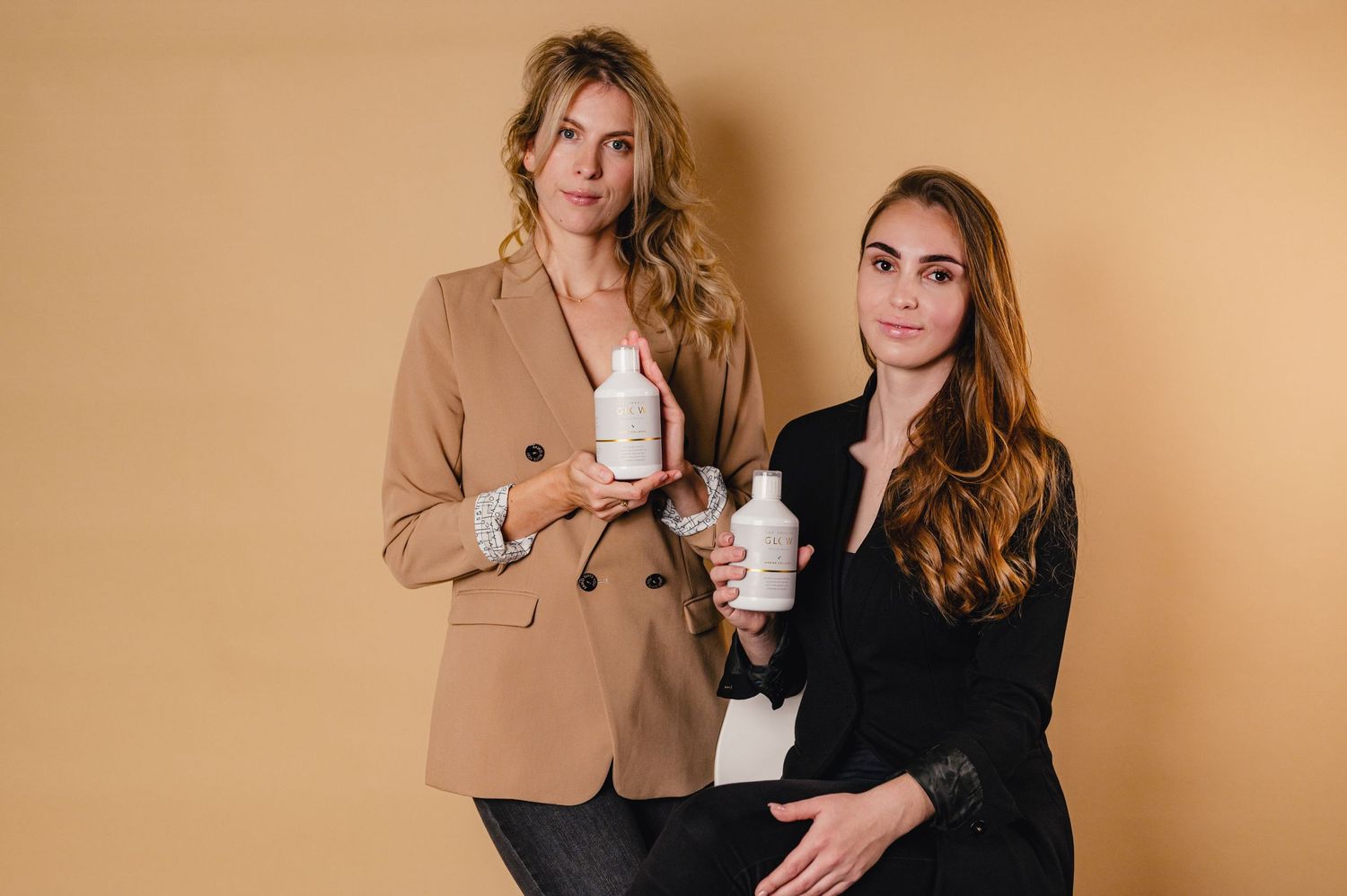 Lifestyle portraits of couple with coffee cups against neutral background.