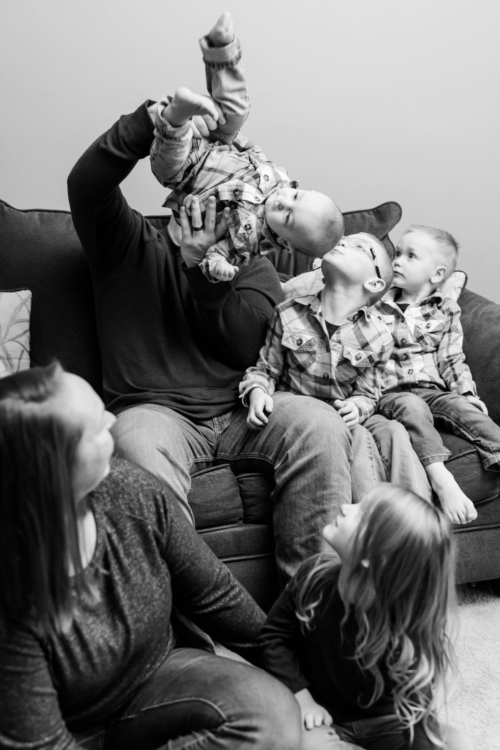 dad holding son upside down