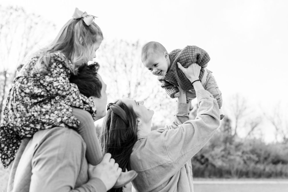 family looking up at baby