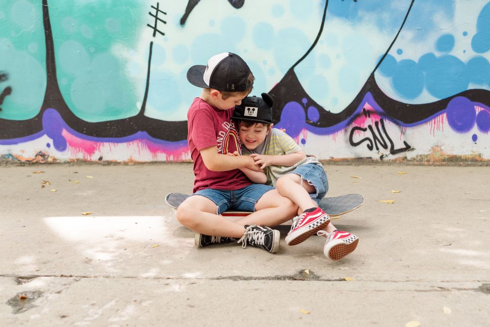 boys on skateboard tickling each other