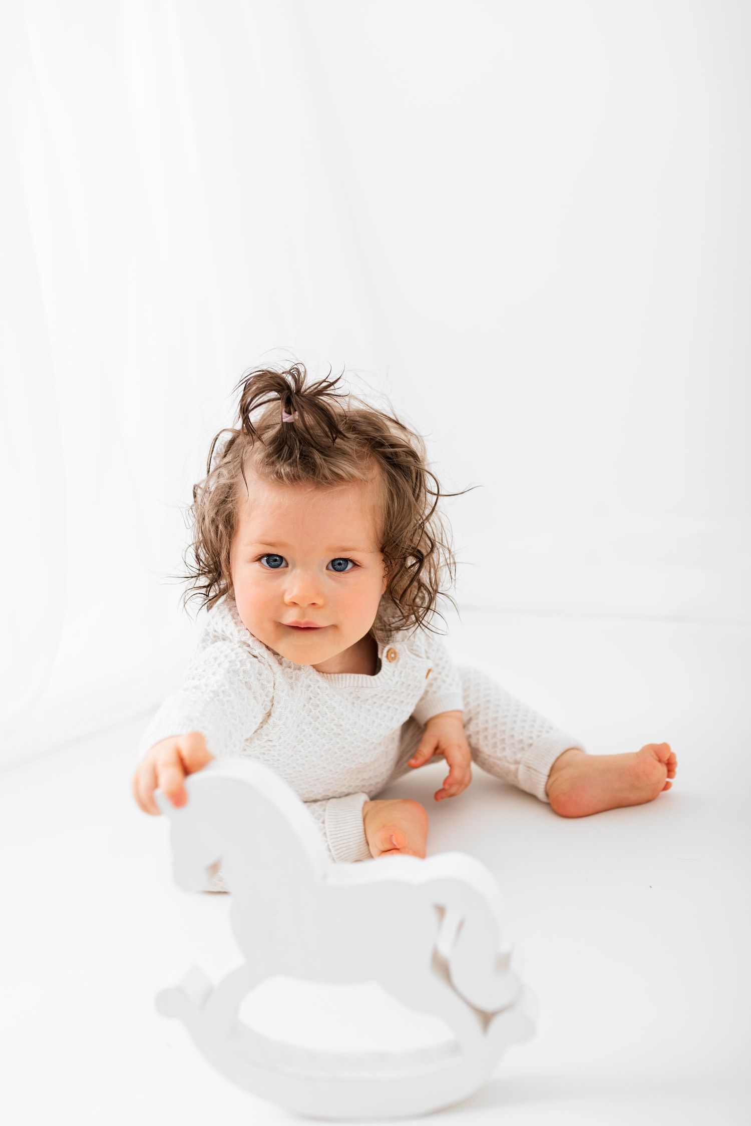 all white baby photos big window