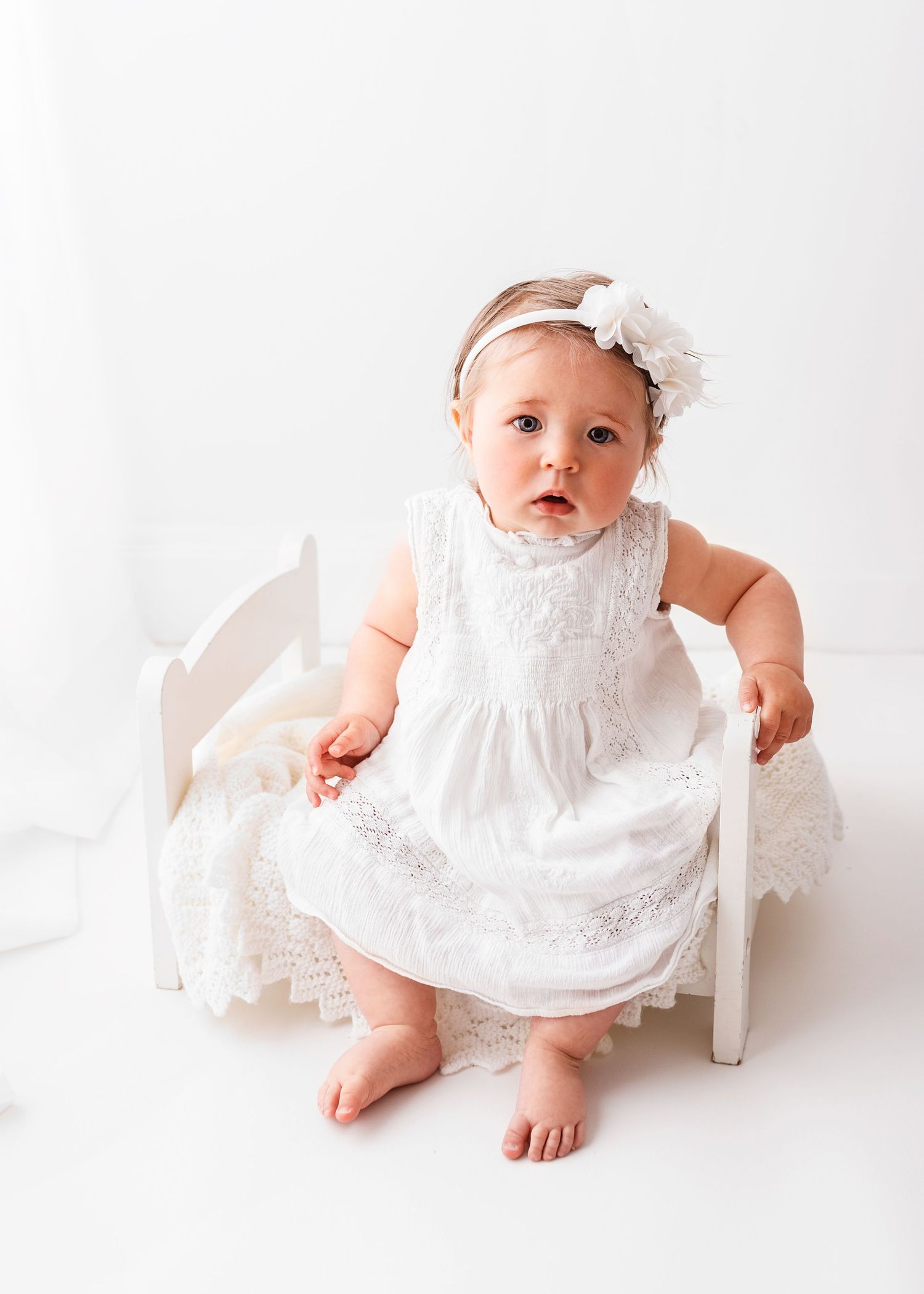 sitter session baby photo on white background in front of the window