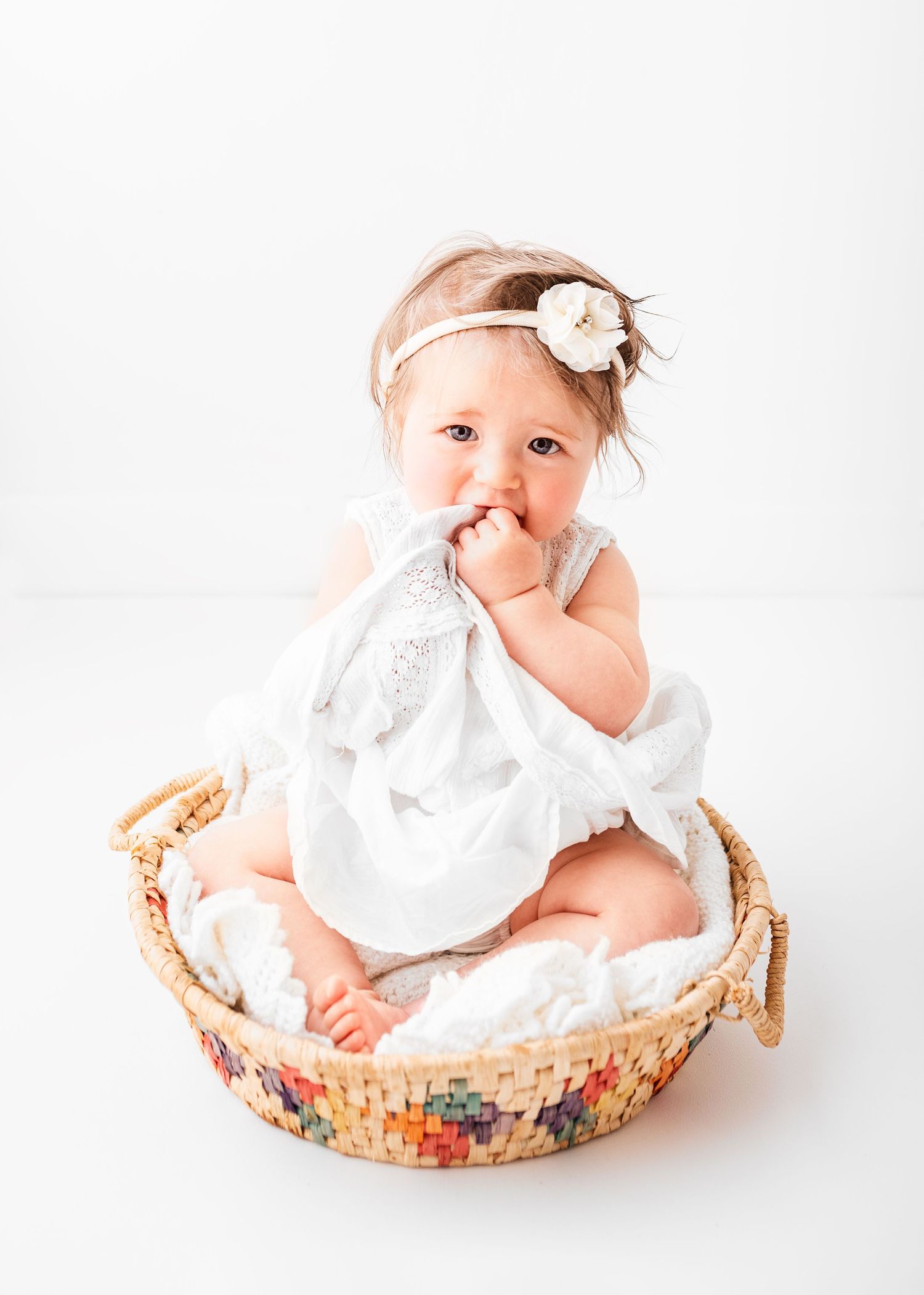 sitter session baby photo on white background in front of the window
