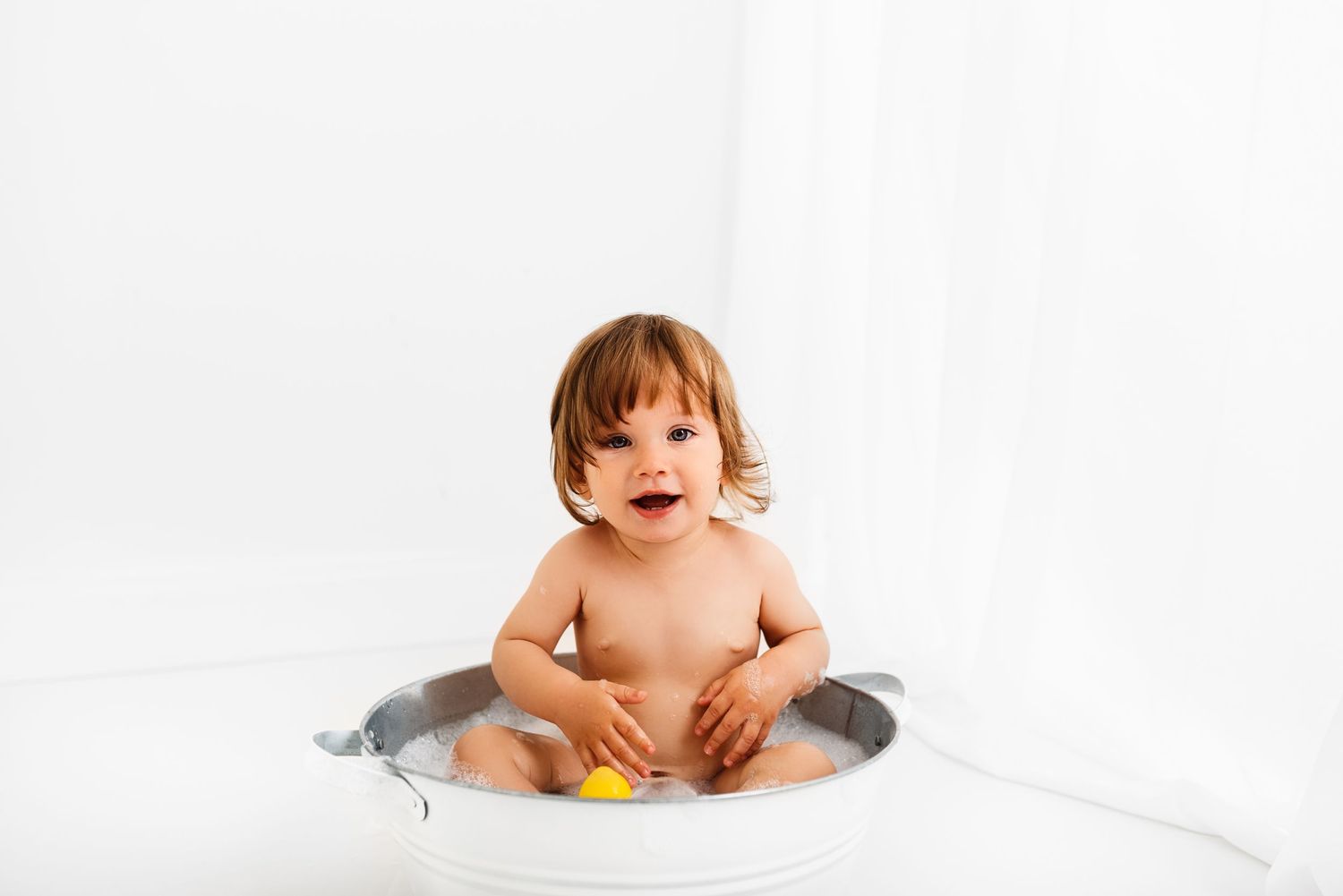 baby all white splash photoshoot with yellow duck Hereford