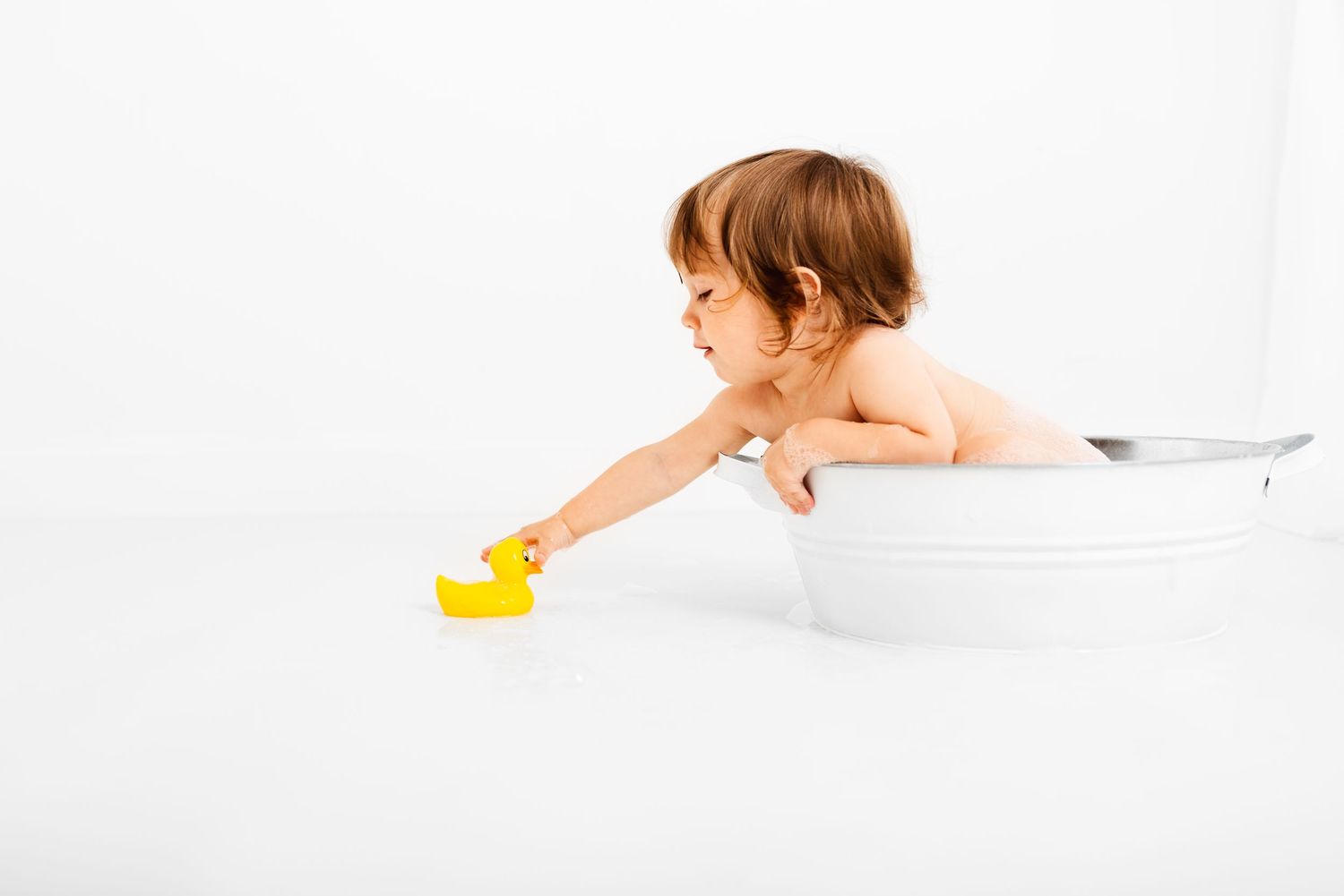 baby all white splash photoshoot with yellow duck Hereford