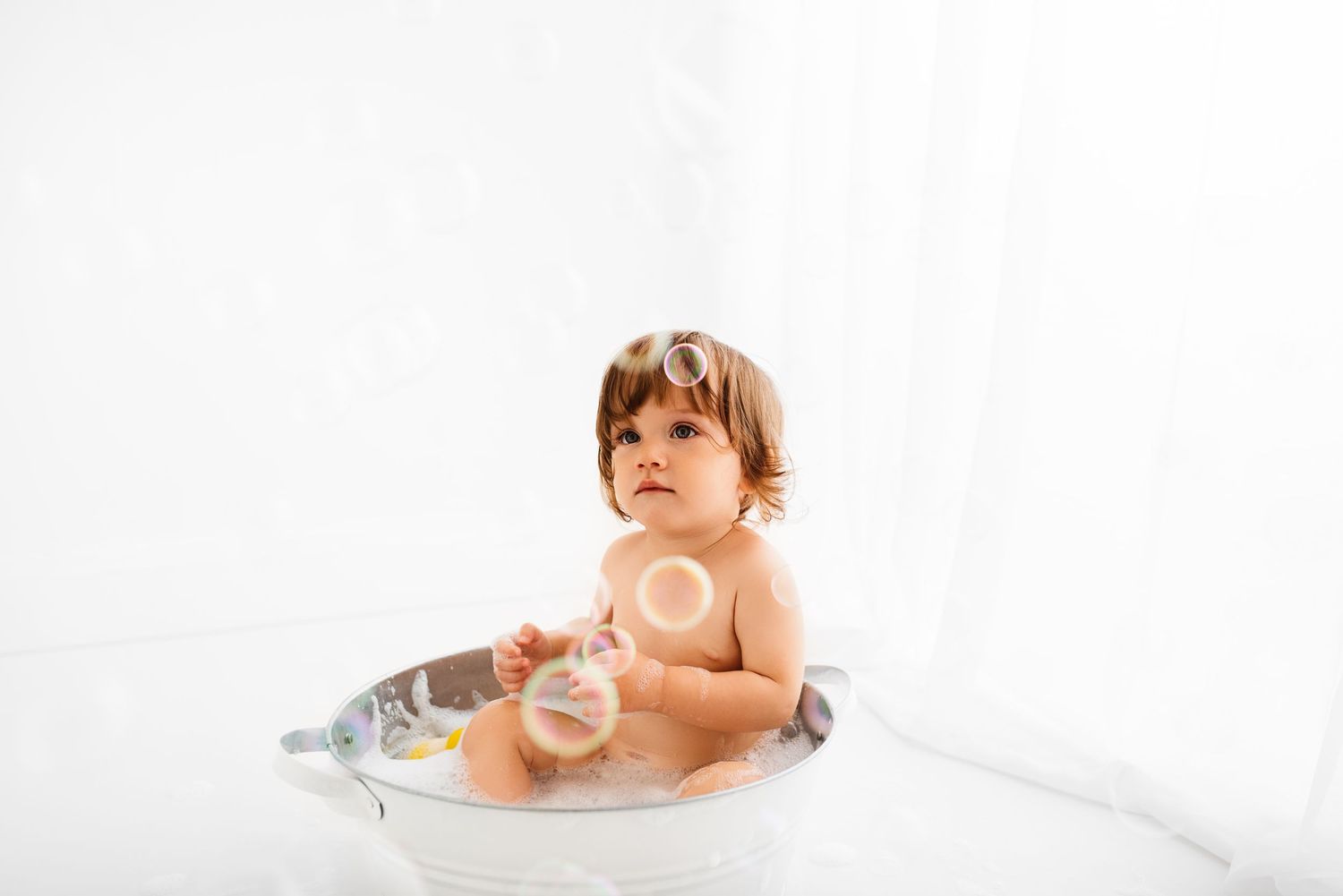 baby all white splash photoshoot with yellow duck Hereford
