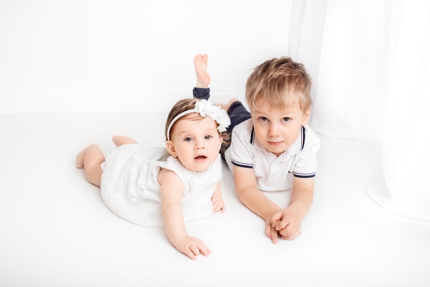baby photo on white background in front of the window siblings
