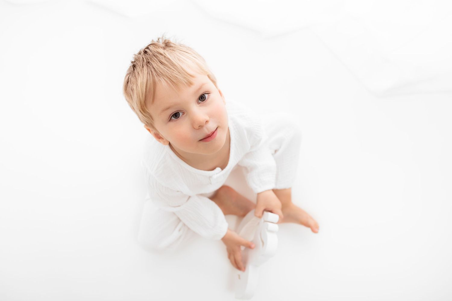 baby photo all white background toddler sitting in front of a window
