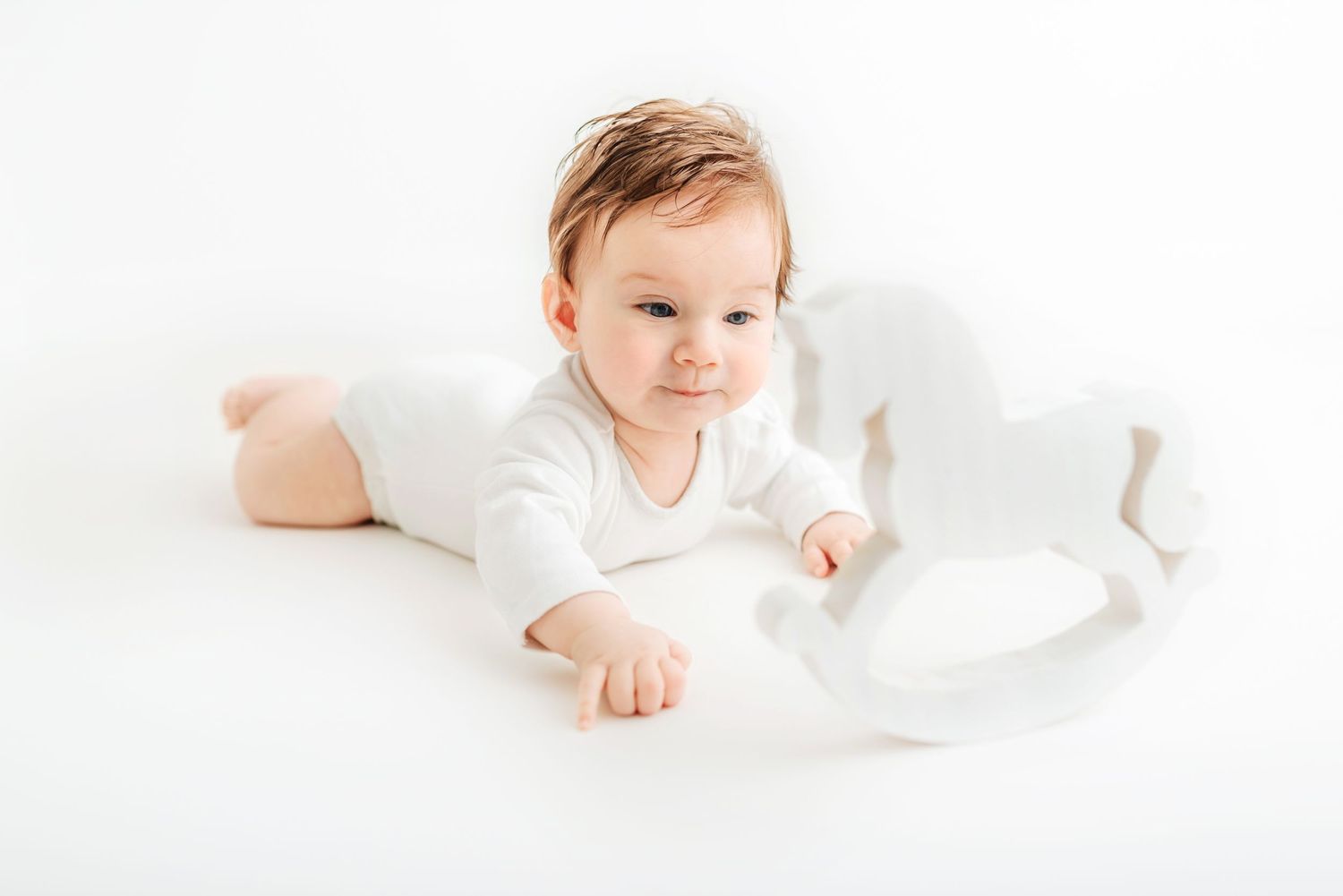 baby photo all white background baby girl with rocking horse