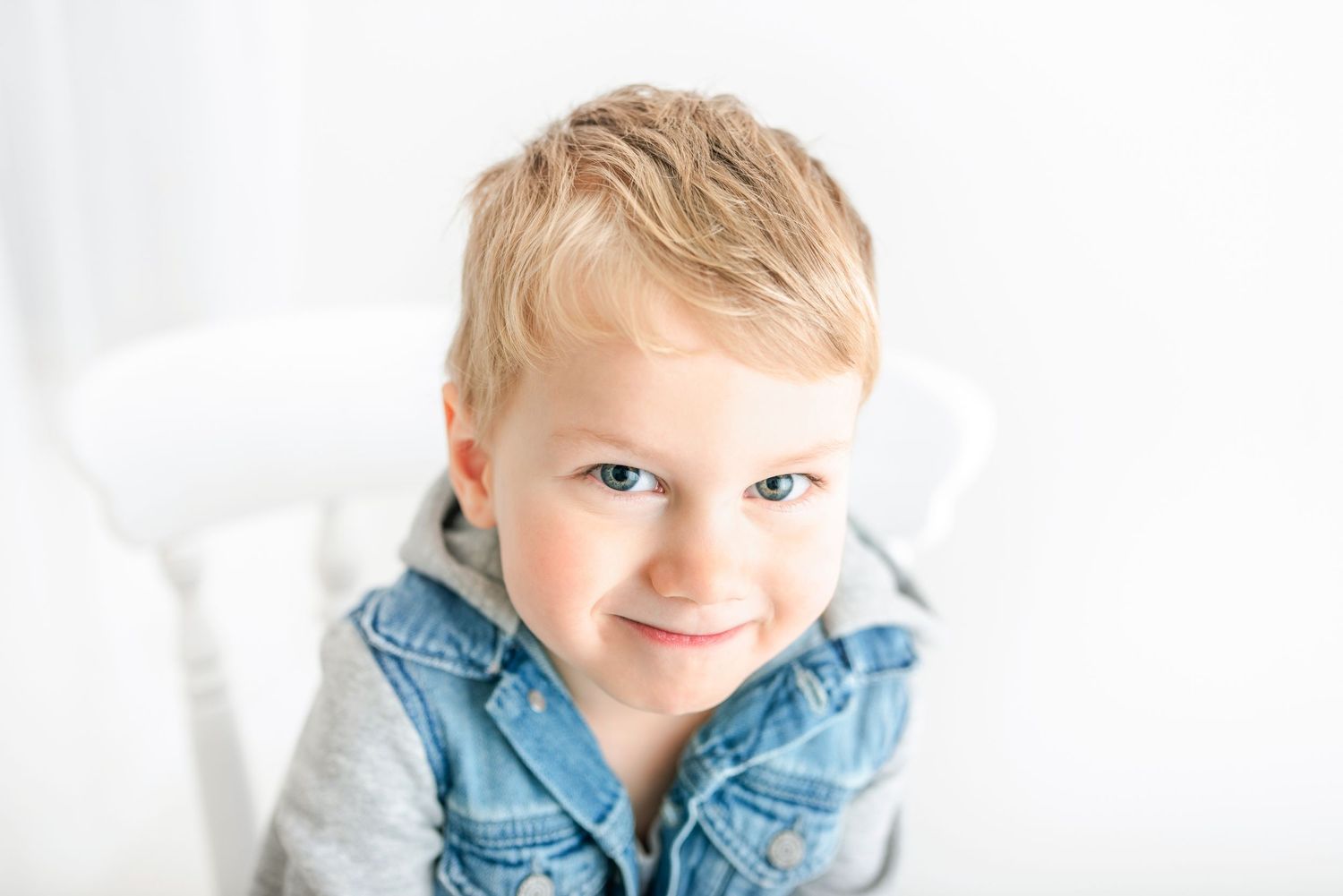 baby photo all white background toddler sitting on a chair