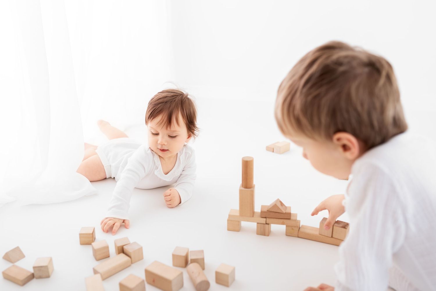 baby photo on white background in front of the window with wooden blocks
