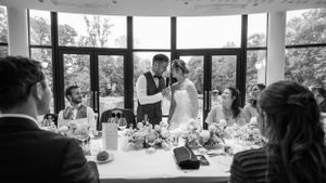 Modern wedding venue interior with large windows overlooking natural scenery.