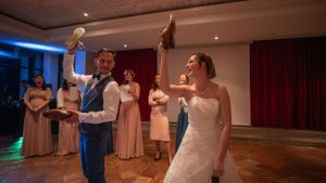 Wedding reception venue decorated with elegant lighting and dance floor setup.
